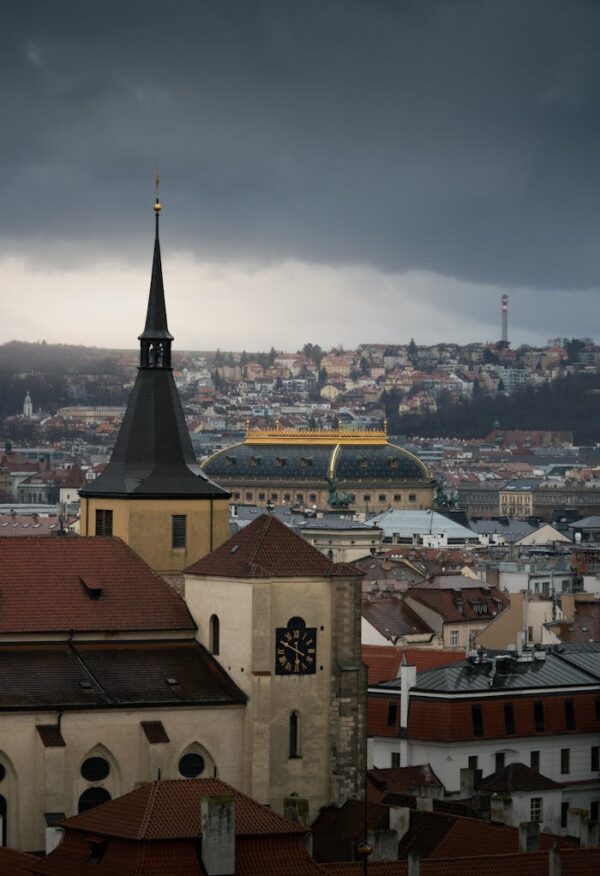Discover a moody cityscape of Prague with stunning dark clouds and historic architecture.
