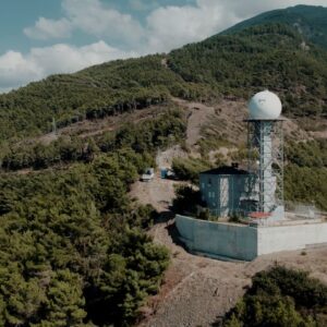 Weather station nestled in the lush mountains of Hatay, Türkiye, under a clear sky.