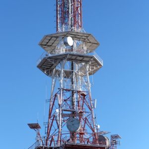A tall communication tower set against a clear blue sky, showcasing modern infrastructure.